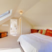 bright-clean-dormer-loft-conversion-bedroom-in-the-decent-size-home-with-beige-carpet
